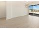 Bright dining area with wood-look tile floor, modern light fixture, and sliding glass doors at 25975 N 160Th Ln, Surprise, AZ 85387