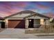 Beautiful house at sunset showcasing its well-maintained exterior and inviting entrance at 25975 N 160Th Ln, Surprise, AZ 85387