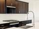 Close-up of a kitchen featuring stainless steel appliances and white subway tile backsplash at 25975 N 160Th Ln, Surprise, AZ 85387