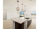 The kitchen features a large island with stylish pendant lighting and modern fixtures at 25975 N 160Th Ln, Surprise, AZ 85387