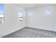 Well-lit bedroom featuring multiple windows and grey carpet at 5923 N 83Rd Ln, Glendale, AZ 85305