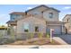 Two-story house with gray siding, stone accents, and a landscaped front yard at 5923 N 83Rd Ln, Glendale, AZ 85305