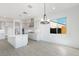 Modern kitchen with white cabinets, quartz countertops, and island at 5923 N 83Rd Ln, Glendale, AZ 85305