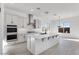 Modern kitchen featuring white cabinets, quartz countertops, and stainless steel appliances at 5923 N 83Rd Ln, Glendale, AZ 85305