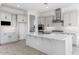 Modern kitchen with white cabinets, a large island, and stainless steel appliances at 5923 N 83Rd Ln, Glendale, AZ 85305