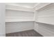 Spacious walk-in closet with ample shelving and hanging rods at 5923 N 83Rd Ln, Glendale, AZ 85305