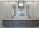 Modern bathroom vanity with double sinks, stylish faucets, and a decorative tile backsplash at 2130 E Turney Ave # 4, Phoenix, AZ 85016