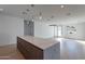 Open-concept kitchen with a large island, modern lighting, and hardwood floors at 2130 E Turney Ave # 4, Phoenix, AZ 85016