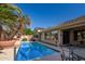 Inviting private pool with desert landscaping, outdoor dining, and home exterior at 15284 W Cottonwood St, Surprise, AZ 85374