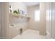 Neutral colored laundry room featuring a shelf decorated with a decorative HOME sign at 1800 N 156Th Dr, Goodyear, AZ 85395