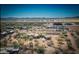 Expansive aerial view showcasing a desert home near McDowell Mountain Park, with open spaces and clear blue sky at 15339 E Red Bird Rd, Scottsdale, AZ 85262
