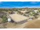 Aerial view showing a large estate with a house, arena, and stables at 15339 E Red Bird Rd, Scottsdale, AZ 85262