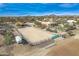 Aerial view of a large property with a house, pool, and arena at 15339 E Red Bird Rd, Scottsdale, AZ 85262