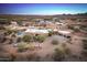 Aerial view of a sprawling desert property with a large house, pool, and guest houses at 15339 E Red Bird Rd, Scottsdale, AZ 85262