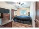 Bright bedroom with wood floors and a large window at 15339 E Red Bird Rd, Scottsdale, AZ 85262
