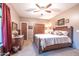 Guest bedroom with a queen-size bed, ceiling fan, and large windows at 15339 E Red Bird Rd, Scottsdale, AZ 85262
