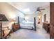 Main bedroom with king-size bed, ceiling fan, and ensuite bathroom access at 15339 E Red Bird Rd, Scottsdale, AZ 85262