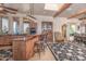 Open kitchen features an island, wooden cabinets, and a dining area at 15339 E Red Bird Rd, Scottsdale, AZ 85262