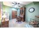 Home office features built-in wooden desk, comfortable chair, and ceiling fan at 15339 E Red Bird Rd, Scottsdale, AZ 85262
