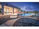Inviting backyard oasis featuring a sparkling pool, patio seating, and fire pit at 15339 E Red Bird Rd, Scottsdale, AZ 85262