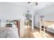 Bright bedroom featuring hardwood floors, built-in bunk beds and a mirrored closet at 22004 W Moonlight Path, Buckeye, AZ 85326