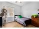 Bright bedroom with hardwood floors and a large window allowing natural light at 22004 W Moonlight Path, Buckeye, AZ 85326