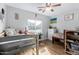 Bright bedroom featuring hardwood floors, ceiling fan, and bunk beds at 22004 W Moonlight Path, Buckeye, AZ 85326