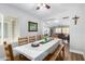 Open concept dining area with hardwood floors, large table, and view into living room at 22004 W Moonlight Path, Buckeye, AZ 85326