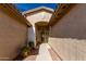 Inviting front entryway featuring a decorative door and stylish archway at 22004 W Moonlight Path, Buckeye, AZ 85326