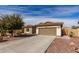 Charming single-story home features a two-car garage, desert landscaping, and a well-manicured front yard at 22004 W Moonlight Path, Buckeye, AZ 85326