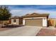 Charming single-story home features a two-car garage, desert landscaping, and a well-manicured front yard at 22004 W Moonlight Path, Buckeye, AZ 85326