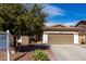 Charming single-story home features a two-car garage, desert landscaping, and a well-manicured front yard at 22004 W Moonlight Path, Buckeye, AZ 85326