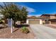 Charming single-story home features a two-car garage, desert landscaping, and a well-manicured front yard at 22004 W Moonlight Path, Buckeye, AZ 85326
