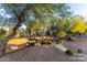 Beautiful backyard featuring mature trees, bridge, rock features, and desert landscaping creating a serene outdoor space at 10647 N 82Nd Pl, Scottsdale, AZ 85260