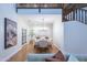 The dining room features hardwood floors, modern furnishings, a chandelier, and staircase at 10647 N 82Nd Pl, Scottsdale, AZ 85260