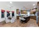 A spacious kitchen featuring wood floors, dark cabinetry, an island, and an eat-in kitchen area at 10647 N 82Nd Pl, Scottsdale, AZ 85260