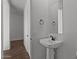 Powder room with a white pedestal sink and modern faucet, offering style and convenience at 12308 W Parkway Ln, Avondale, AZ 85323