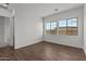 Bright bedroom featuring wood floors and two windows providing ample natural light at 12308 W Parkway Ln, Avondale, AZ 85323