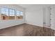 Wood floor bedroom with two windows and neutral walls, creating a serene atmosphere at 12308 W Parkway Ln, Avondale, AZ 85323