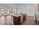 Kitchen features stainless steel appliances, wood cabinets, granite counters, dishwasher, and center island with sink at 12308 W Parkway Ln, Avondale, AZ 85323