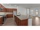 Kitchen features stainless steel appliances, wood cabinets, tile backsplash, granite counters, and center island at 12308 W Parkway Ln, Avondale, AZ 85323
