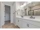 Bright bathroom with a double vanity, modern fixtures, and a walk-in shower with tiled walls at 18711 E Panchito Dr, Gold Canyon, AZ 85118