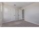 A spacious bedroom with neutral carpet, and convenient access to other areas of the home at 18711 E Panchito Dr, Gold Canyon, AZ 85118