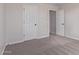 A bedroom with neutral walls and carpet with white doors and black hardware at 18711 E Panchito Dr, Gold Canyon, AZ 85118