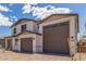 Two-story home featuring a three-car garage and a paved driveway at 18711 E Panchito Dr, Gold Canyon, AZ 85118