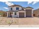 Charming two-story home featuring a three-car garage and desert landscaping, perfect for curb appeal at 18711 E Panchito Dr, Gold Canyon, AZ 85118