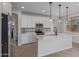 This kitchen showcases stainless appliances, quartz counters, white cabinets, and pendant lighting over an island at 18711 E Panchito Dr, Gold Canyon, AZ 85118