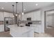 Modern kitchen features white cabinets, stainless steel appliances, an island and stylish pendant lighting at 18711 E Panchito Dr, Gold Canyon, AZ 85118