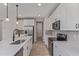 Lovely kitchen with stainless appliances, white cabinets, an island with a sink, and tiled backsplash at 18711 E Panchito Dr, Gold Canyon, AZ 85118
