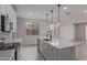 Bright kitchen with white cabinets, stainless steel appliances, quartz counters and pendant lighting over island at 18711 E Panchito Dr, Gold Canyon, AZ 85118